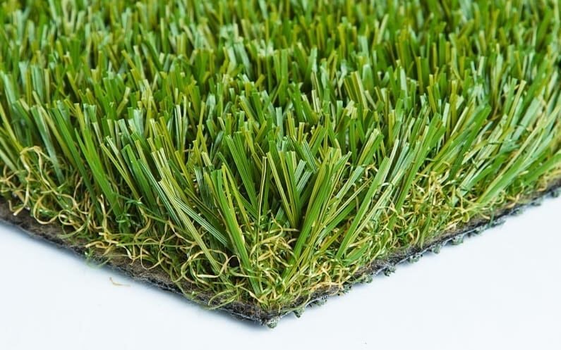 Close-up of synthetic grass blades with a textured backing.