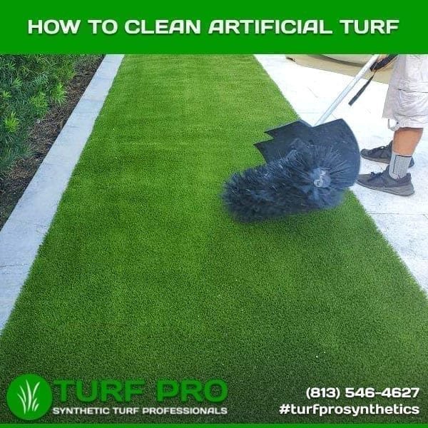 Demonstration of cleaning artificial turf with a specialized brush.