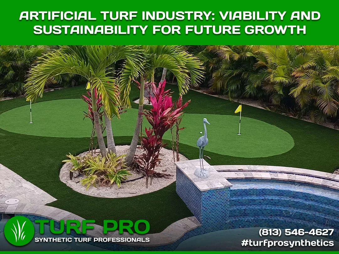 Artificial turf golf putting green by a pool with tropical plants.