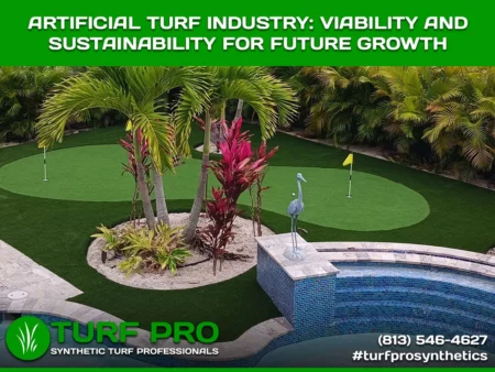 Artificial turf golf putting green by a pool with tropical plants.