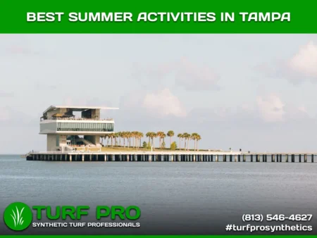 Modern pier structure with palm trees and seating areas over calm water at sunset.