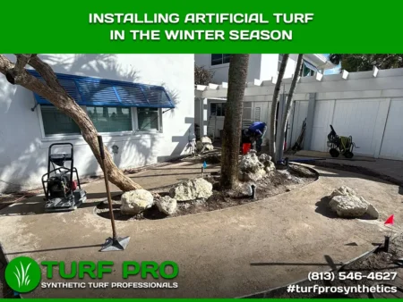 Installing Artificial Turf In The Winter Season Workers installing artificial turf outdoors during winter season.